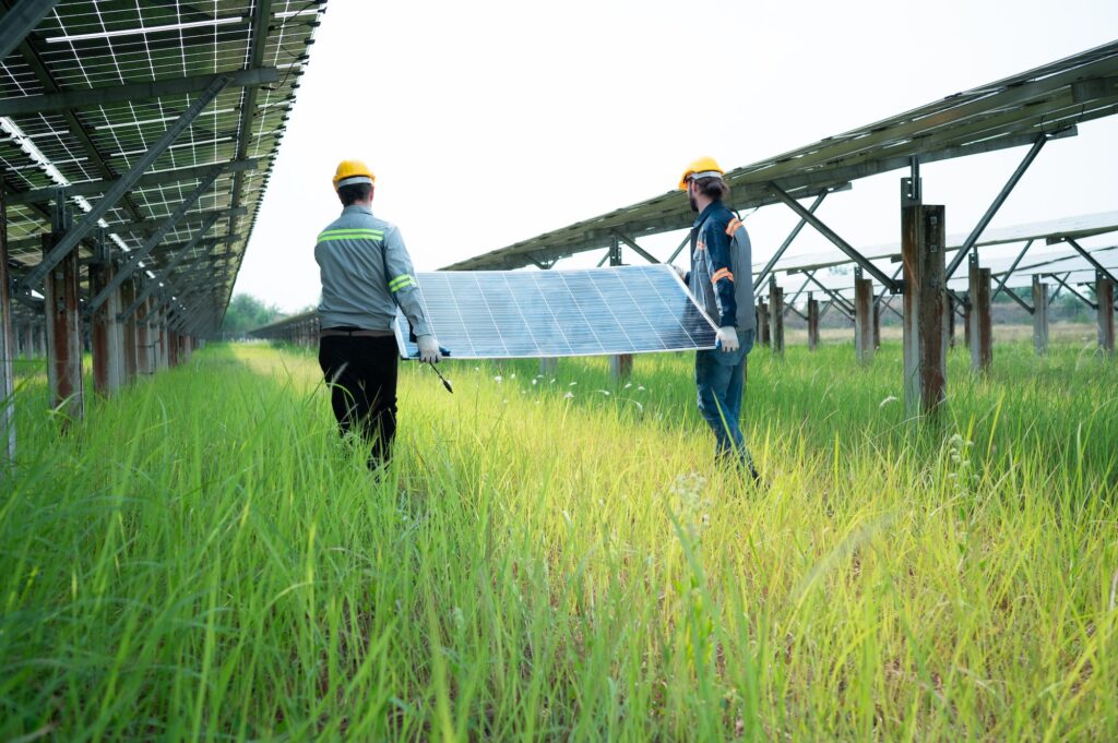 Engineering and technician unloading repaired solar panels to be installed