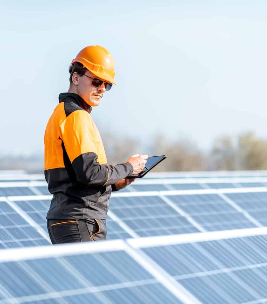 Engineer servicing solar panel on electric plant